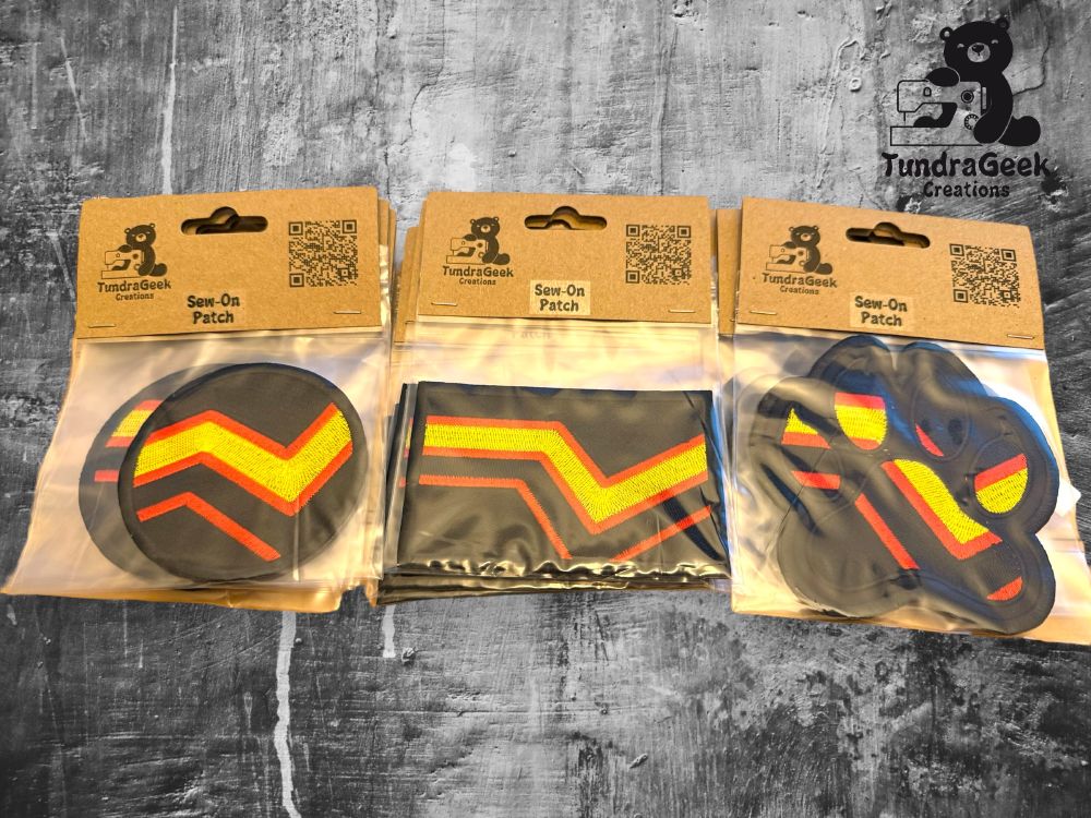 picture of three different shapes of embroidered patches with the rubber pride flag embroidered onto them