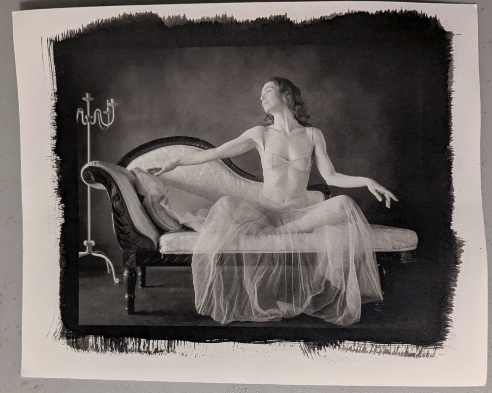 Model Jay ban poses on a chaise in a sheer dress. Platinum-palladium toned kallitype.