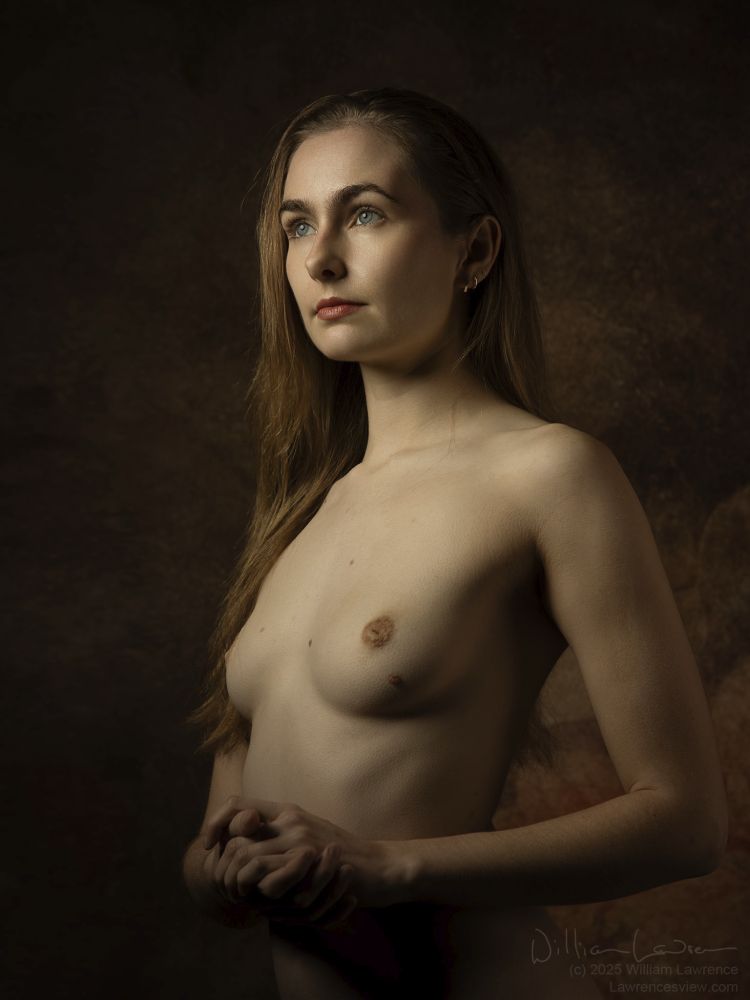 Head and torso photograph of model Mighty Earthling,  standing nude, gazing off into the distance.  