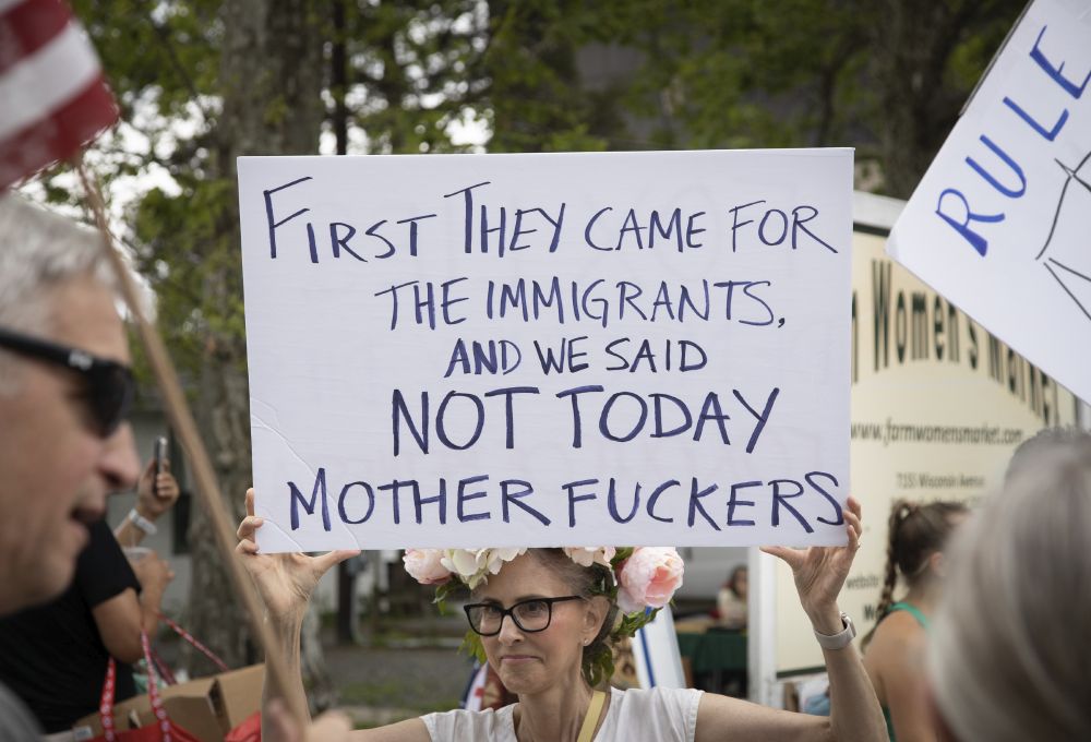 Woman holding sign saying 
