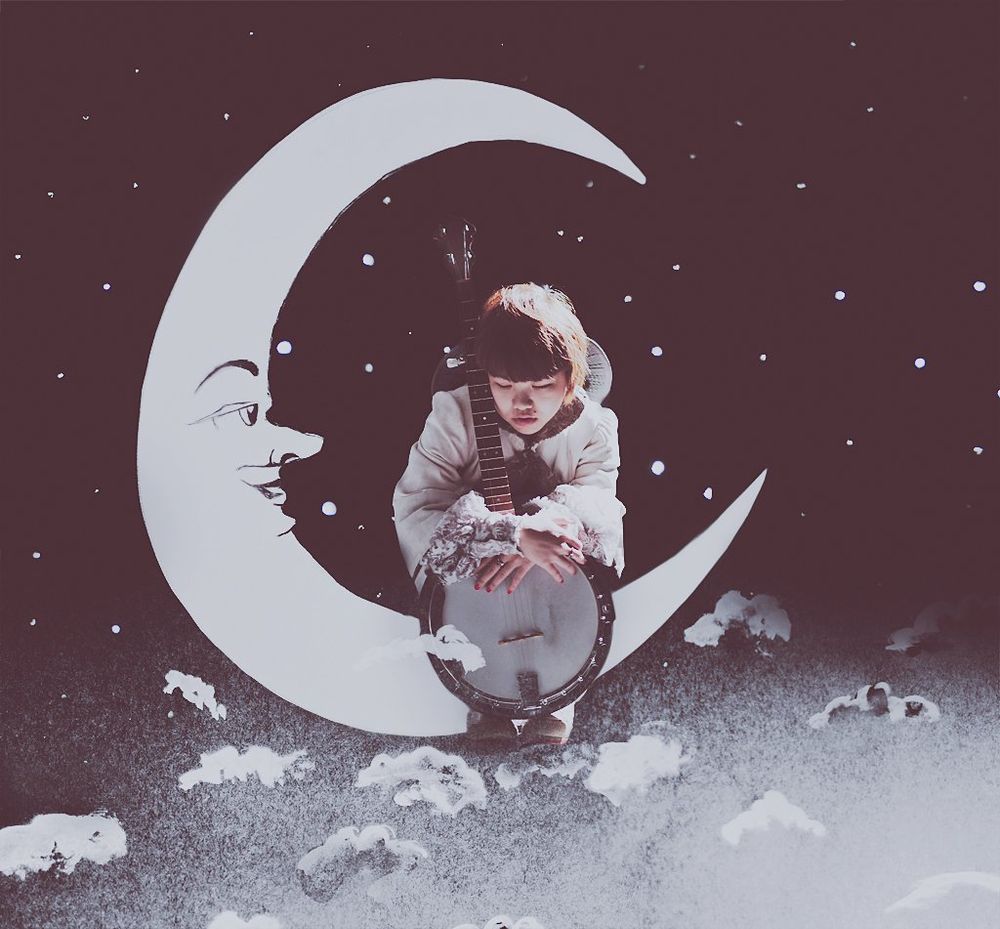 photo illustration of a hunched over girl sitting on a paper crescent moon, clutching a banjo. she is surrounded by a sky of stars and some clouds below her.