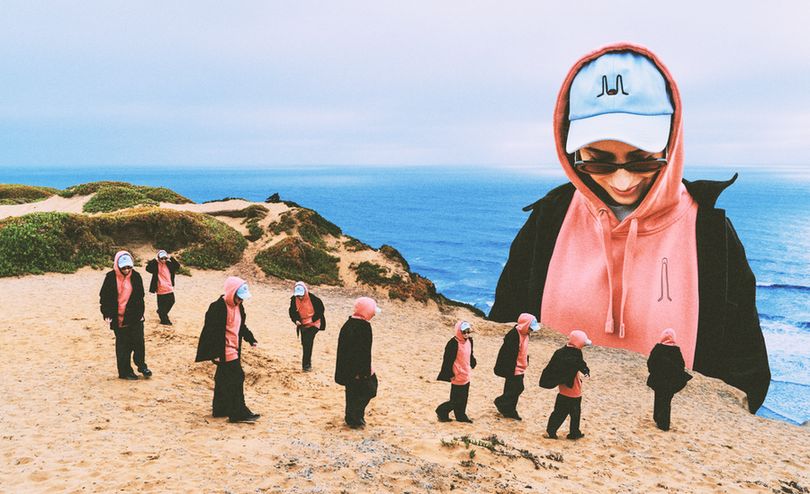 a photoshopped collage of 9 identical people walking close to a cliff overlooking the ocean. there's one giant version of the same person looking down lovingly at the little versions of herself. every single one of them is wearing a dusty rose hoodie, a blue baseball cap, with a black jacket and pants.