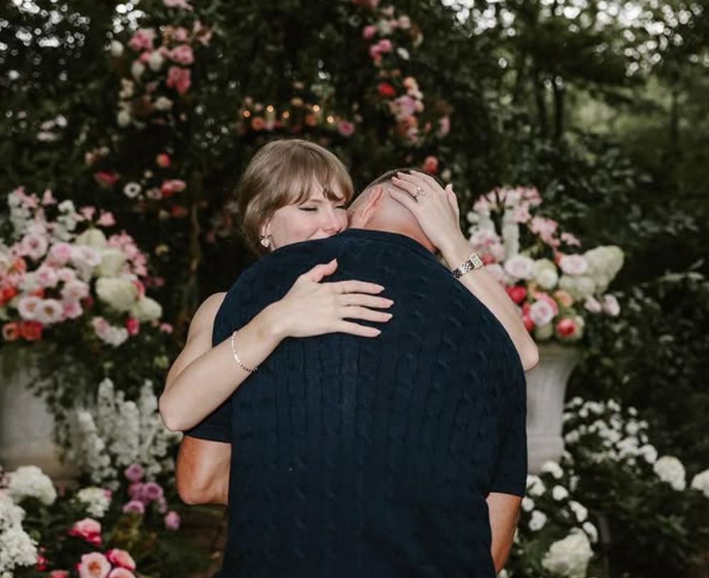 Taylor Swift hugging Travis Kelce.