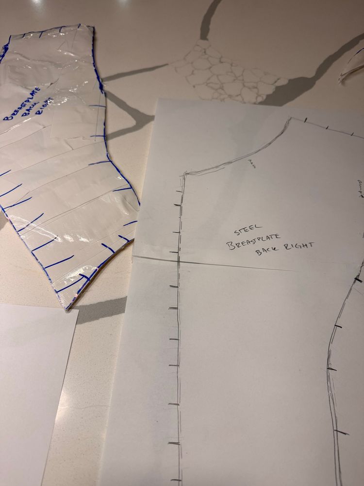 Two breastplate pattern components on a white countertop. 