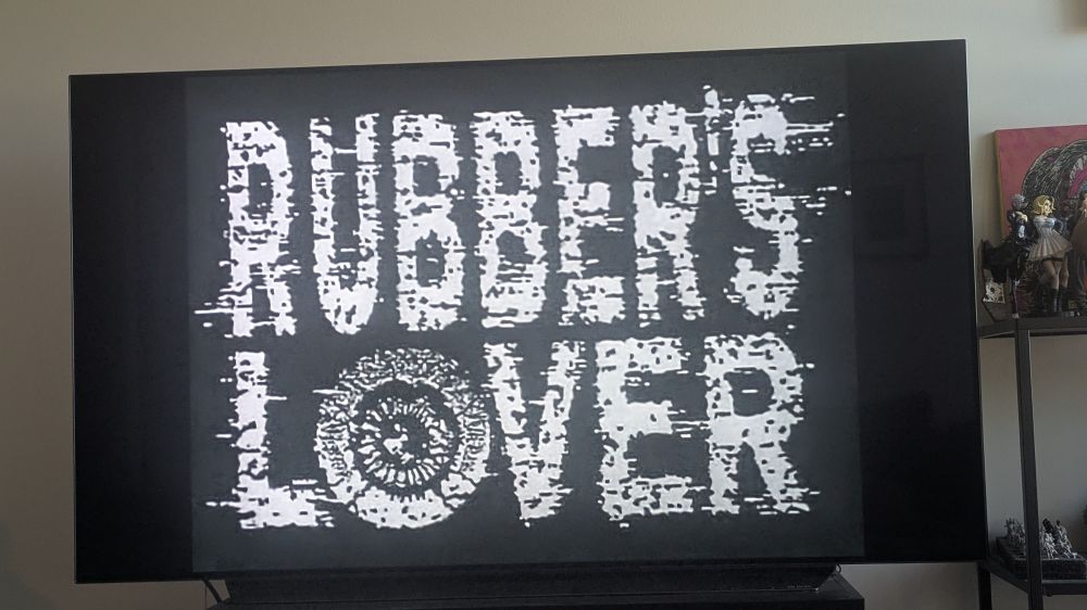 A tv screen showing the opening title of Rubber's Lover