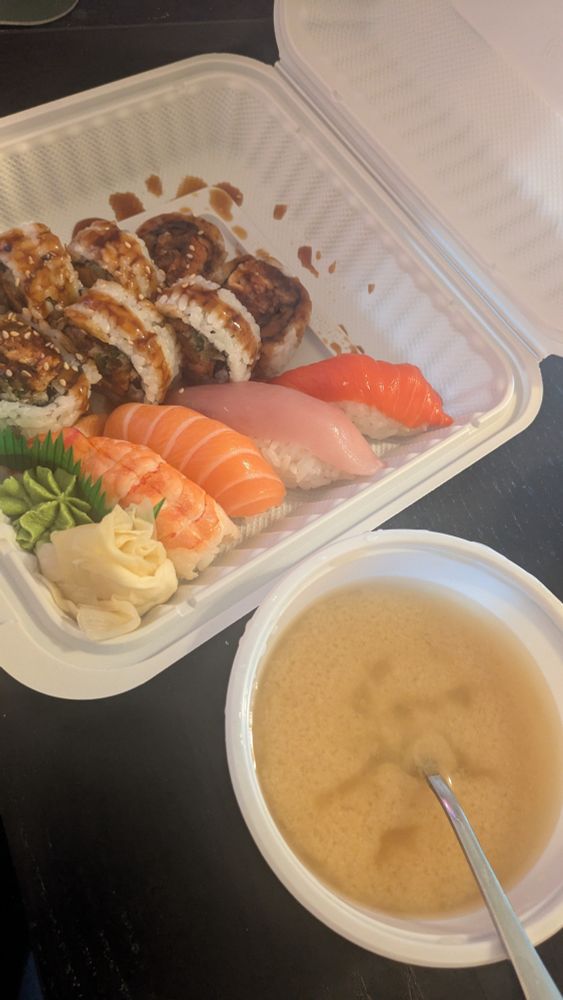 A variety of sushi roll and nigiri with miso soup.