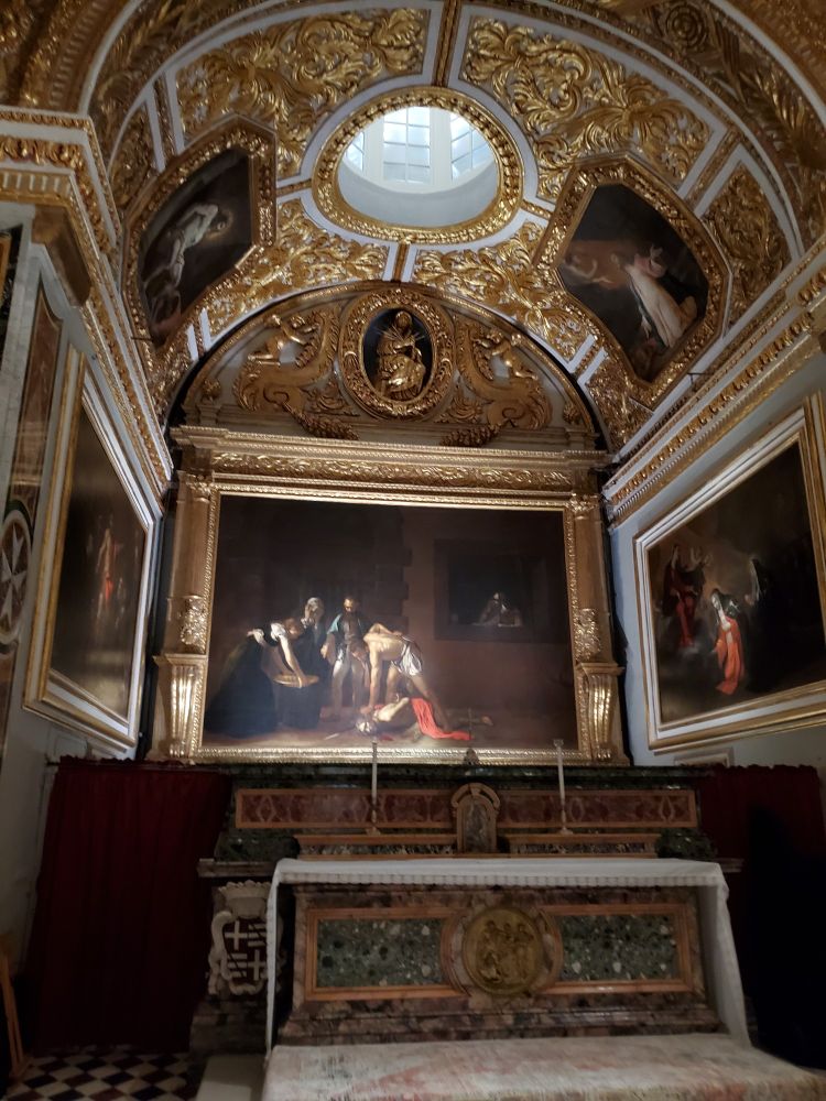 The Beheading of St John the Baptist, by Caravaggio. The largest one he painted and the only one he signed.