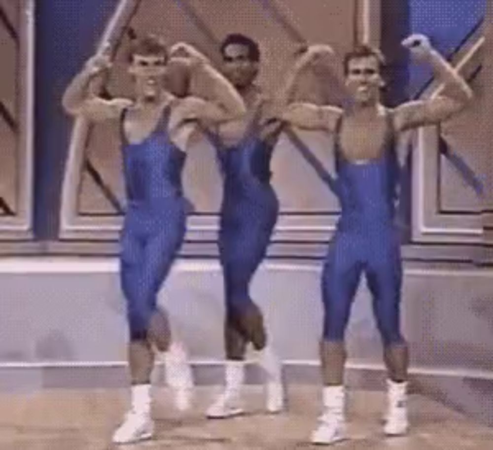 three men in blue leotards are flexing their muscles while dancing .