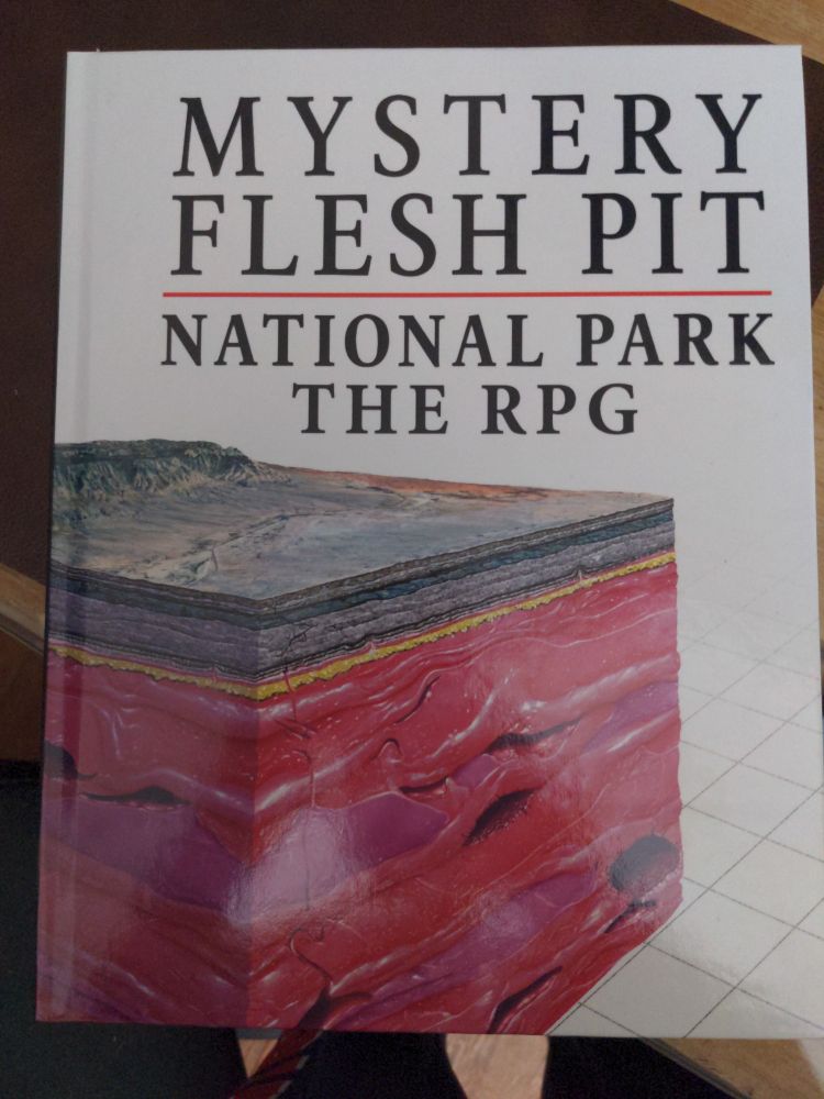 Mystery Flesh Pit National Park the RPG cover black text on white cover with an illustration of the ground cut away to reveal it is flesh underneath