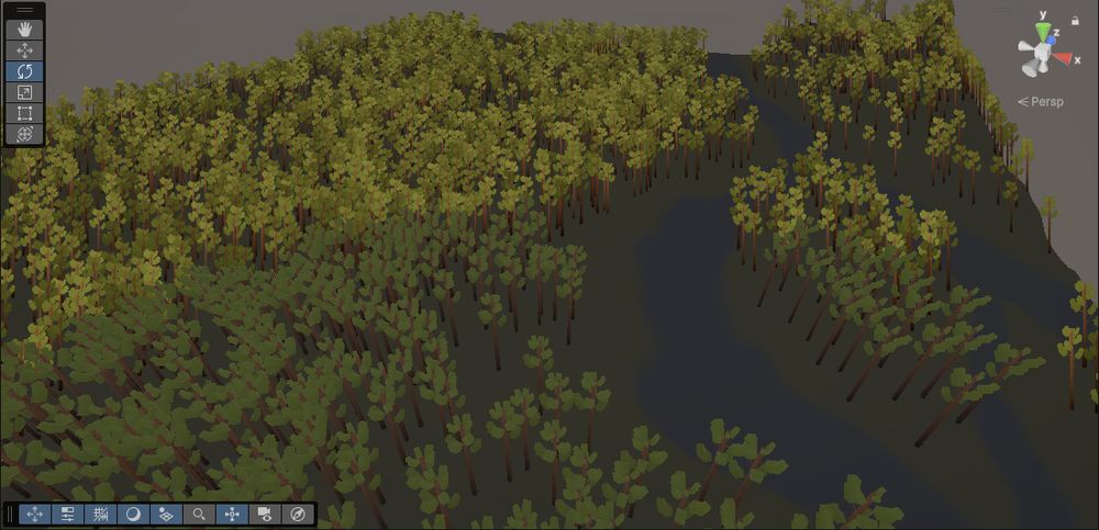 A small patch of Unity Terrain with a large forest on the left side and a branching river bed on the right side, blending into a moutain.