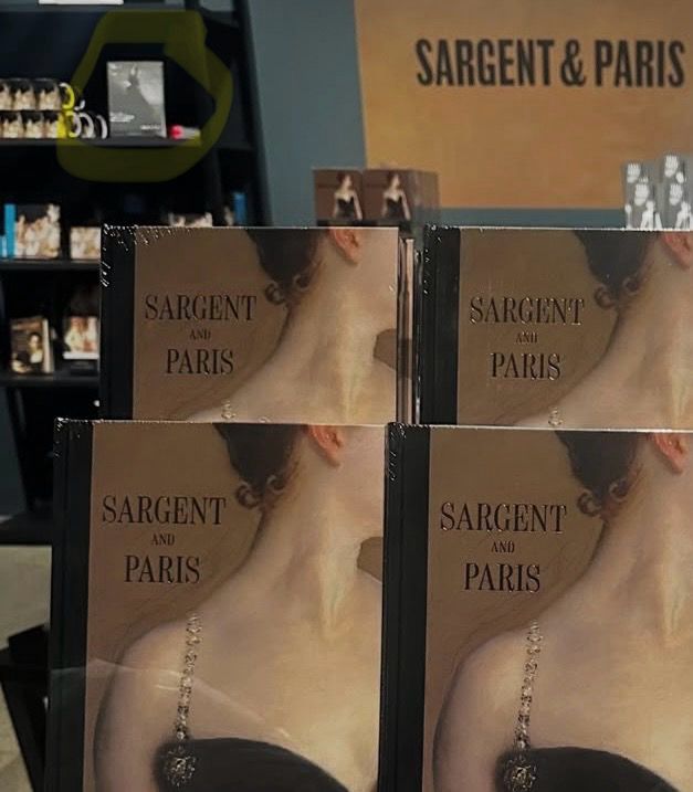 Sargent and Paris catalogues with a close crop of a white woman’s neck and a tiny view of The Art of Parisian Chic on a bookshelf behind.