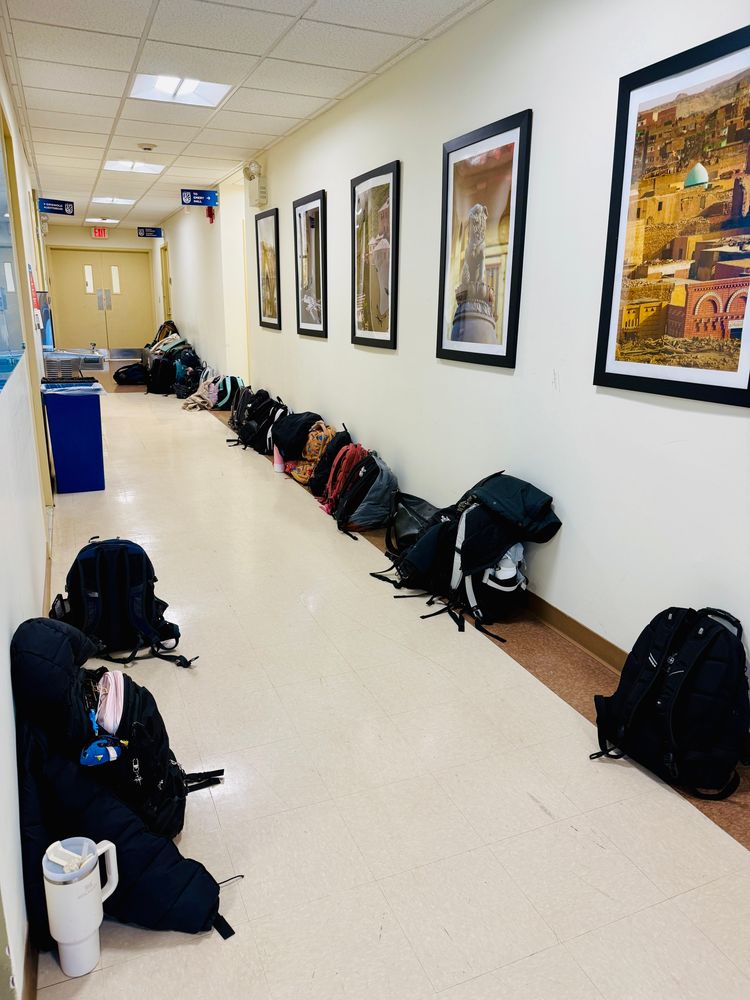 Backpacks lining a hallway
