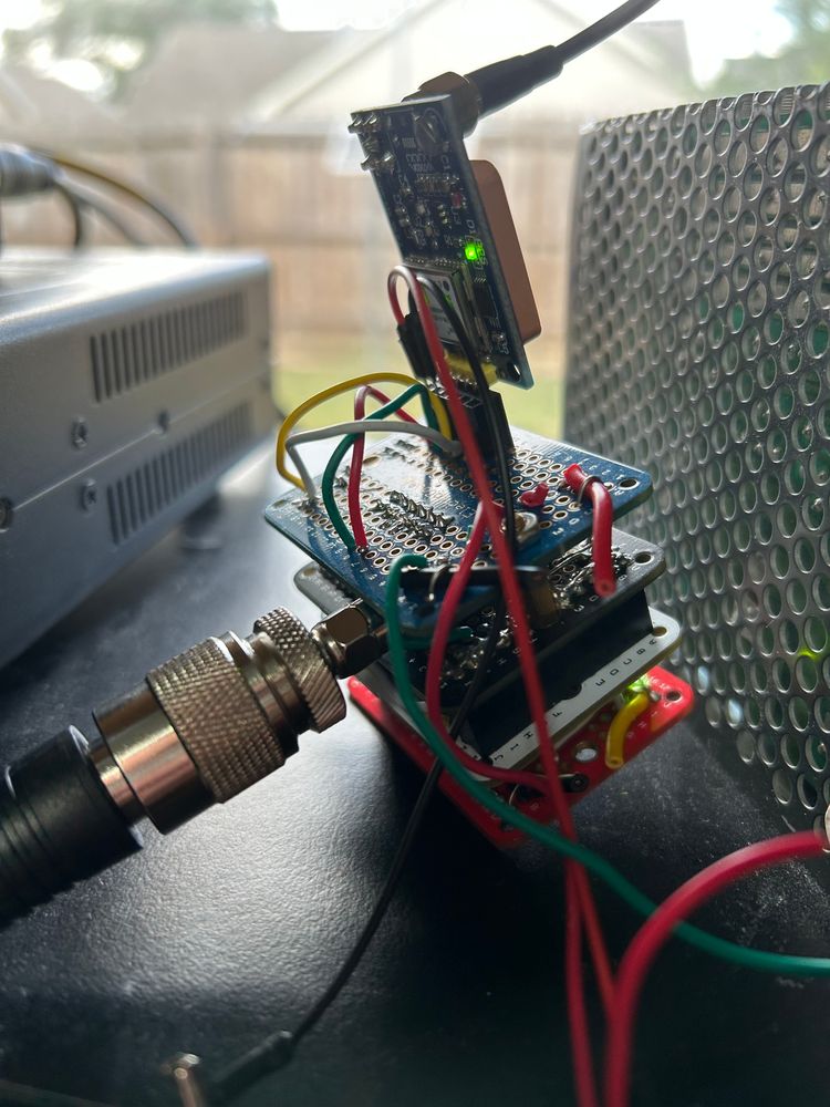 Picture of my wspr transmitter. It consists of 5 boards. The bottom board is the microcontroller. The second board has the Si5351 oscillator. The third board is an apropriate Low Pass Filter (LPF), the antenna hangs off of that board. The top board allows the GPS module to connect. It's kind of messy as I was trying various ways to power it. Right now I just have a temporary power solution. 