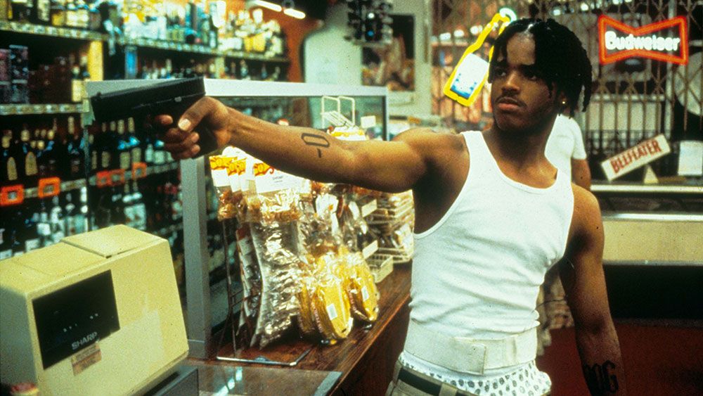 Larenz Tate pointing a gun in Menace II Society
