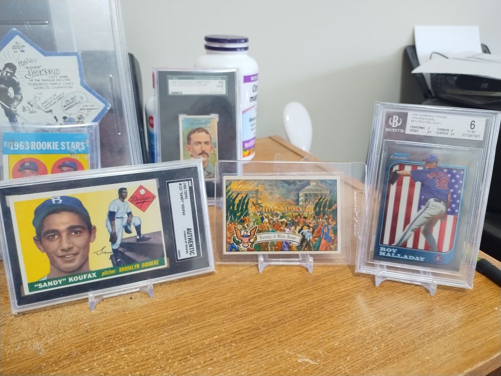 Sandy Koufax rookie card, Burning of the White House card, Roy Halladay rookie card