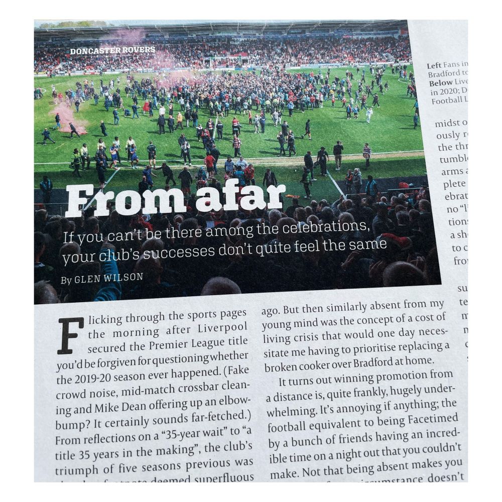A close up of the opening paragraph of an article titled ‘From afar’ by Glen Wilson, on the page it’s accompanied by an image of Doncaster Rovers fans invading the pitch in April 2025 to celebrate promotion from League Two.