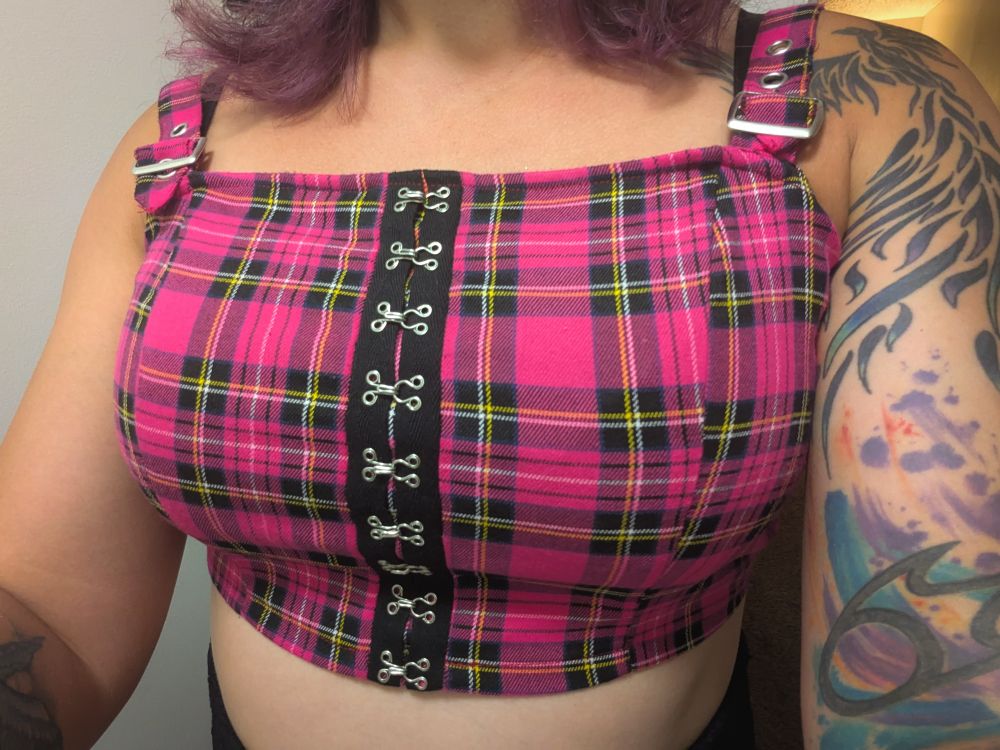 A very 90s pink tube top, with boobs inside it. 
