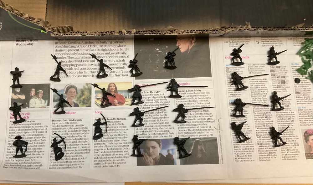 1/72 scale Renaissance figures sprayed painted black set out on newspaper. 