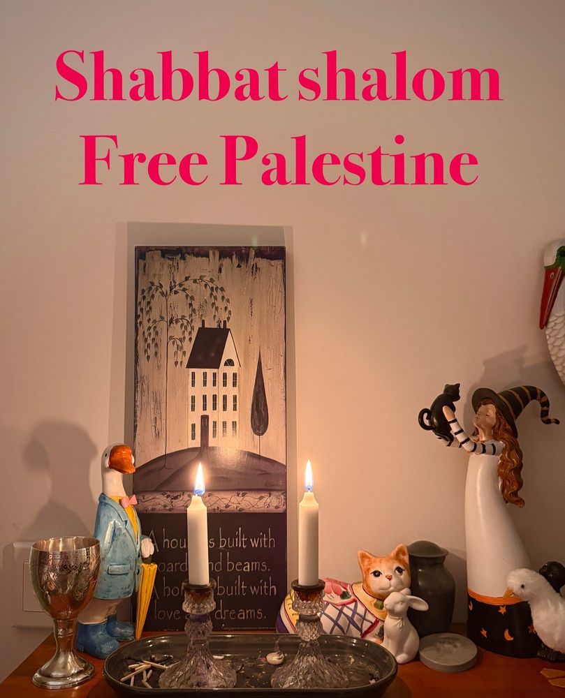 Shabbat candles and a bunch of bric-a-brac on with the words “Shabbat shalom, free Palestine” written above.