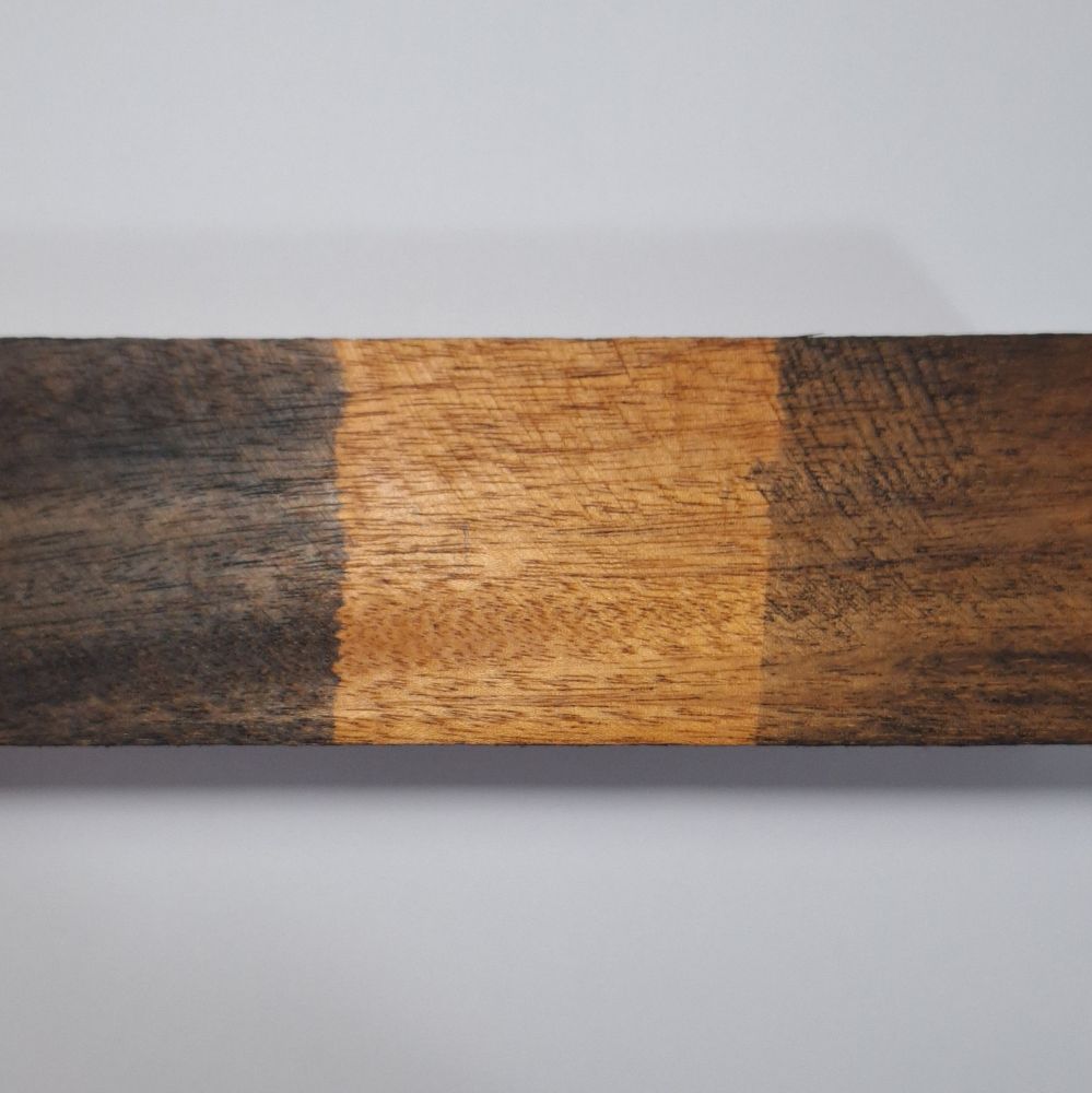 A block of mahogany. The left third is ebonised with Iron(II) Acetate and tea (Yorkshire gold). The middle third is raw untreated wood and the right third is treated with Iron(II) Acetate.
