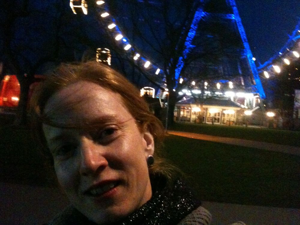 Benita in front of the Prater Ferris wheel at night