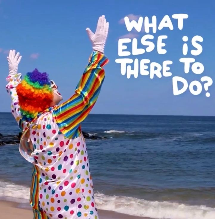 clown staring at the sky on a beach, what else is there to do 