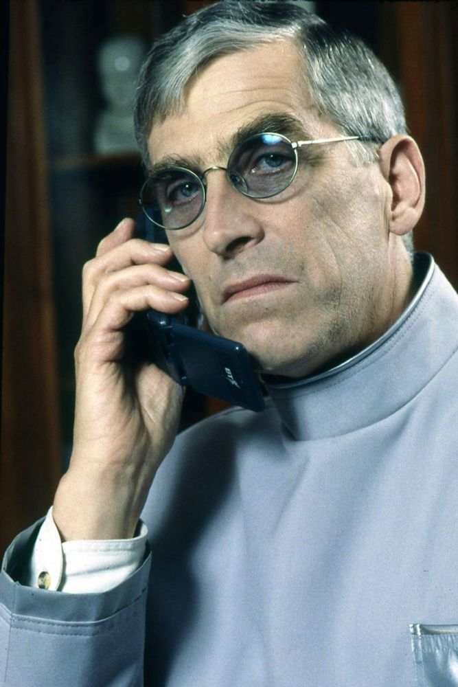 The demon headmaster holding an early BT flip phone