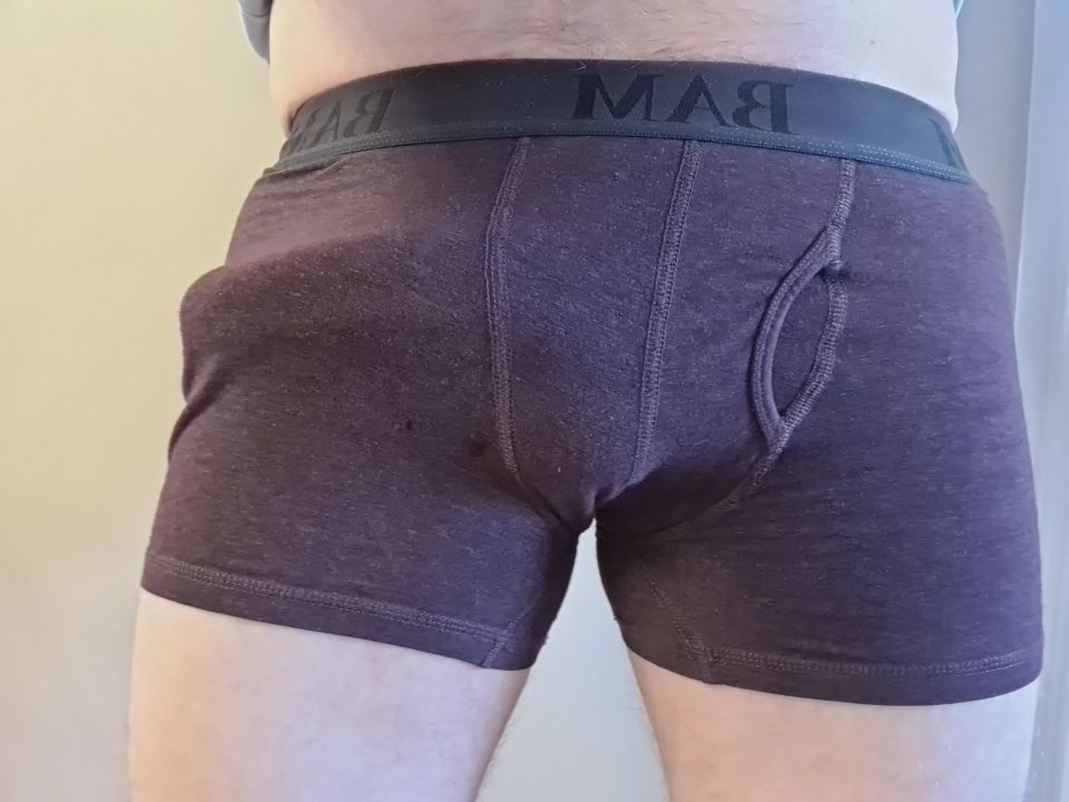 Purple boxers showing a bulge that wraps around onto the hip