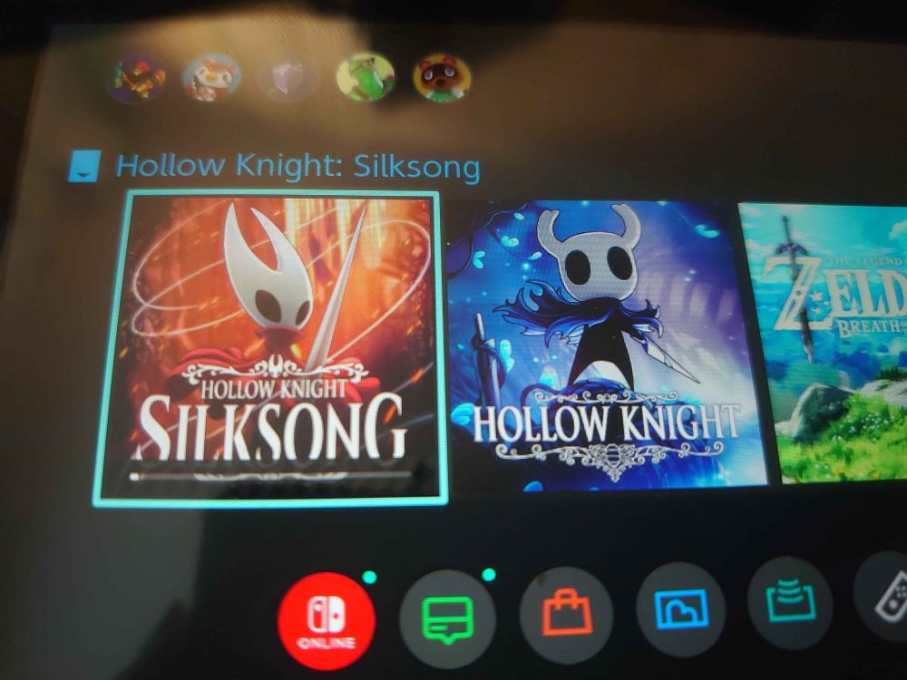 Photo of a switch downloading Hollow Knight Silksong