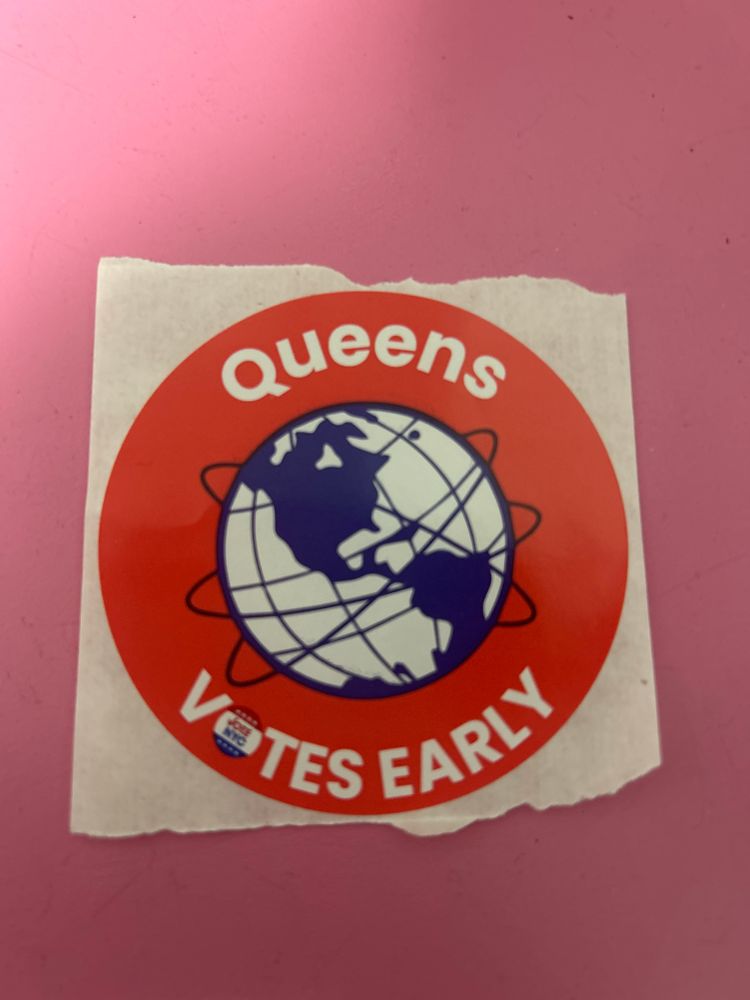 A red sticker says “Queens Votes Early” and features an illustration of the  unisphere  