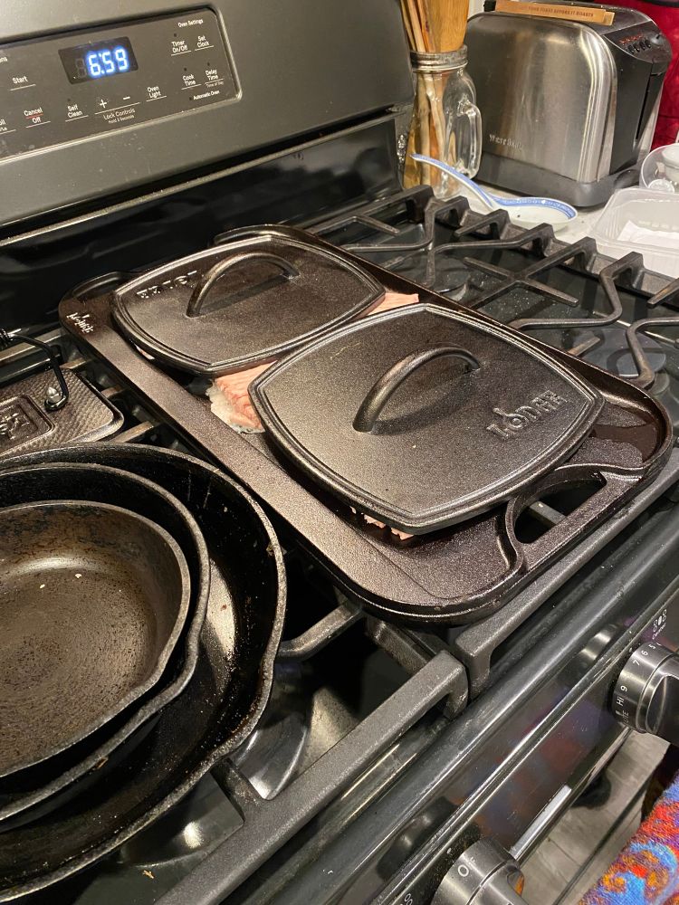 Turkey on griddle with two iron presses on top