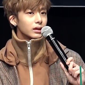 Hyungwon of Monsta X holding a microphone