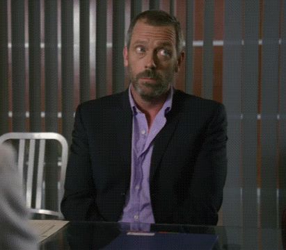 a man in a suit is sitting at a table