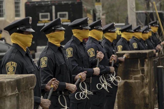 Picture of fully masked police officers from the TV show Watchemtn