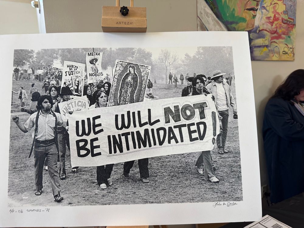 A black & white photo from the Chicano moratorium of Chicano kids holding up a as protest sign that says “We will not be intimidated!”