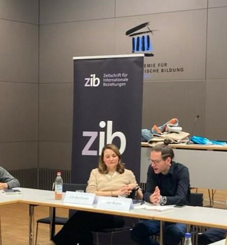 two presenters in front of zib roll-up