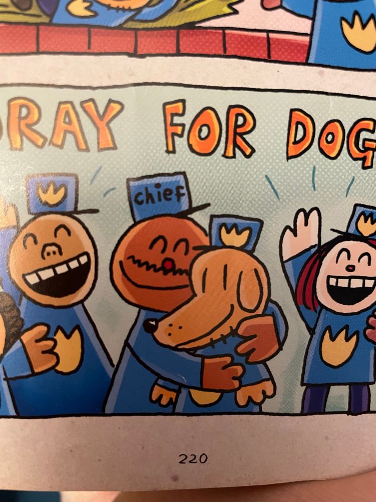 Hooray for dogman!
Police chief is happy and hugs dogman. Other police people are cheering in background 