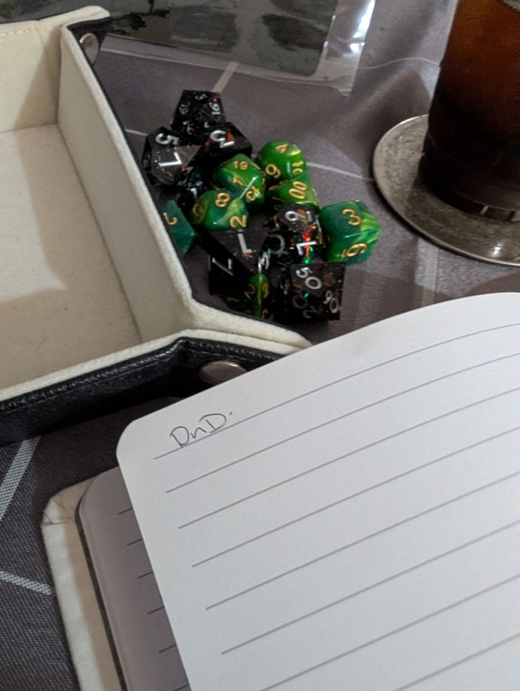 Some DnD dice, and a notepad with "DnD" written on it. For DnD-ing!
