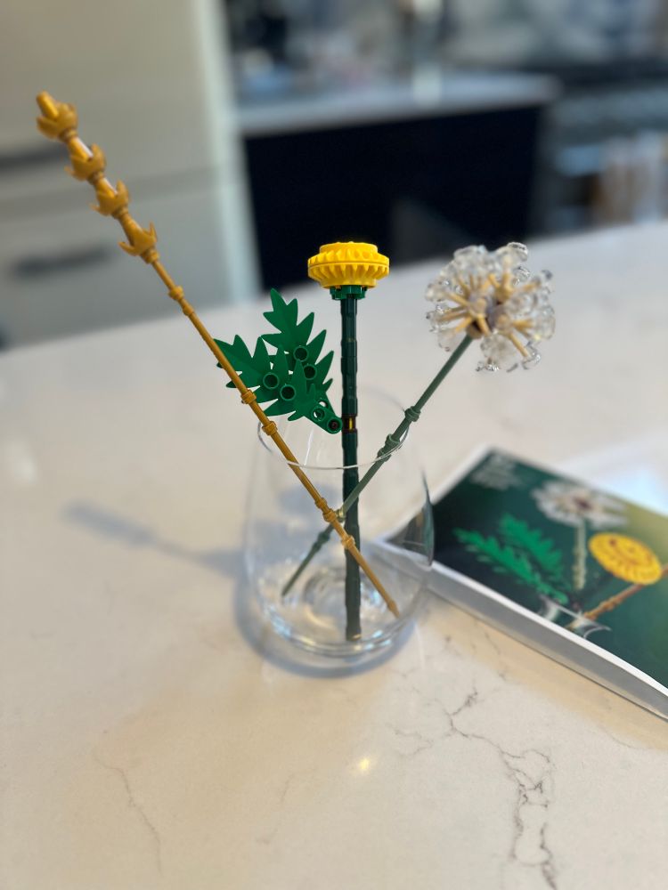 A small set of Lego flowers, including a dandelion clock made with nice clear Lego pieces 