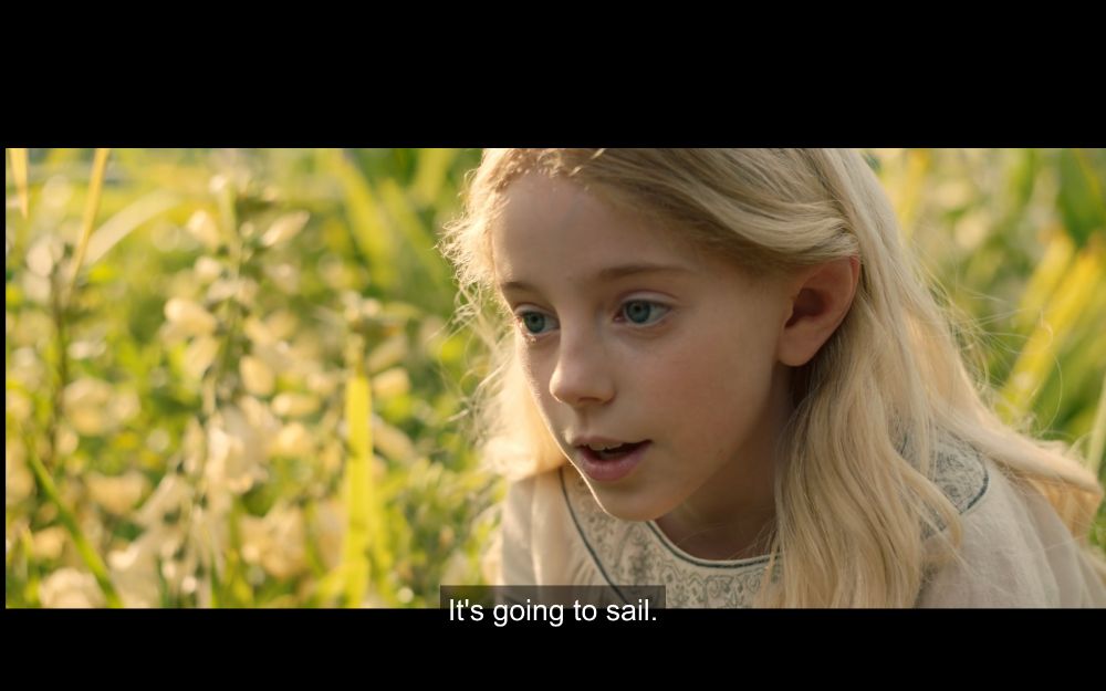 Galadriel as a kid in The Rings of Power; subtitles recite: "It's going to sail"