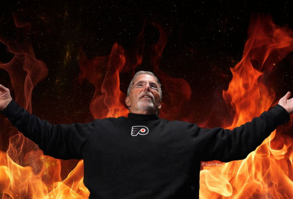 Flyers head coach John Tortorella leaning back with his arms spread wide. There are flames behind him like the famous Elmo flames gif.