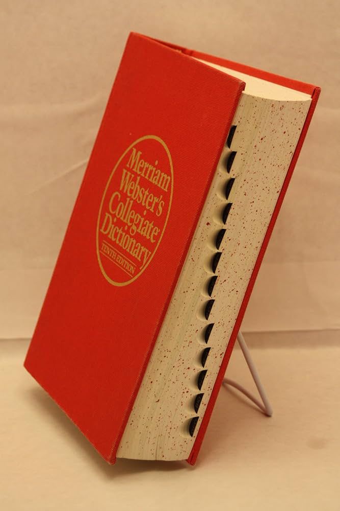 An image of a red Merriam Webster’s Collegiate Dictionary with speckled edges and letter tabs along the side