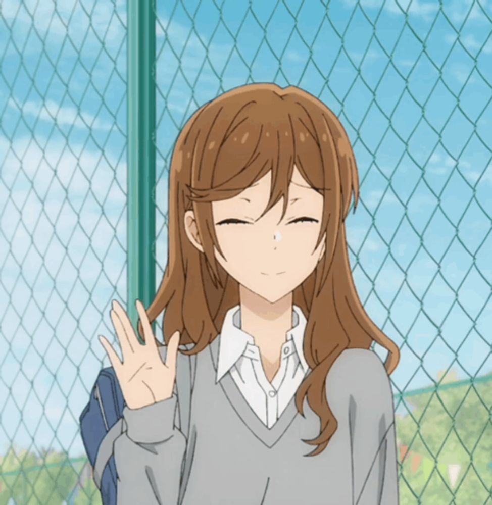 a girl with long brown hair is standing in front of a chain link fence with her eyes closed