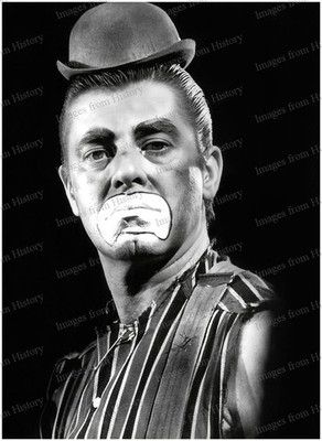 Still from the mercifully lost film, “The Day The Clown Cried” (1972): Jerry Lewis looking disdainfully at the camera, wearing a shirtless clown costume with a microscopic bowler hat.  