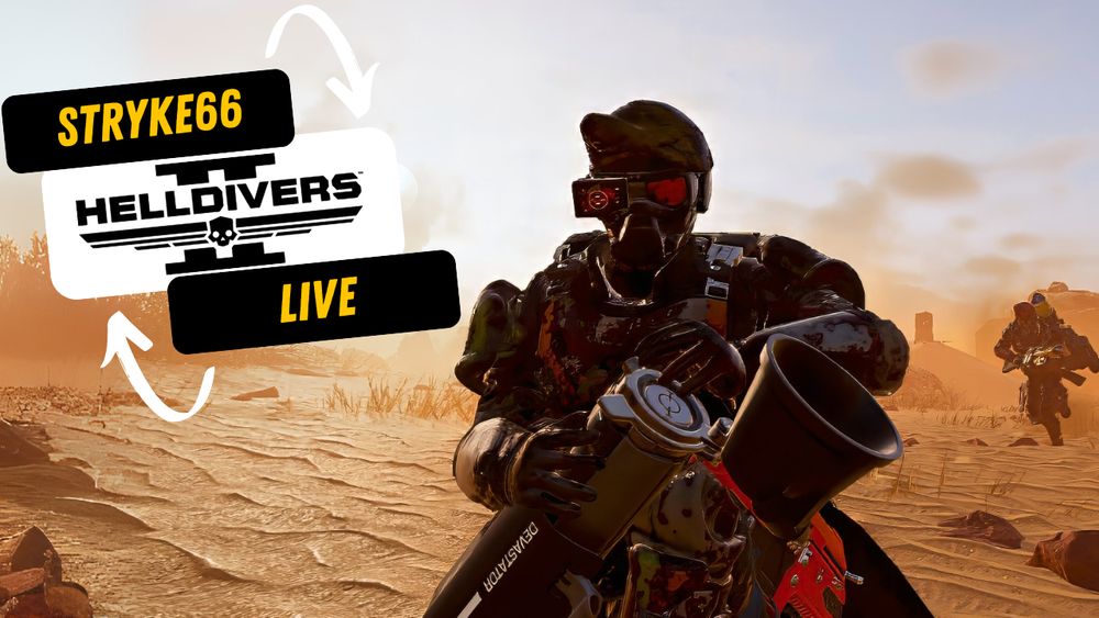 A Helldiver reloads a devastating weapon on a scorched desert world in Helldivers 2. Sand whips around him as a squadmate rushes up from the background to join the fight. The setting sun casts long shadows as Managed Democracy is delivered one bullet at a time.