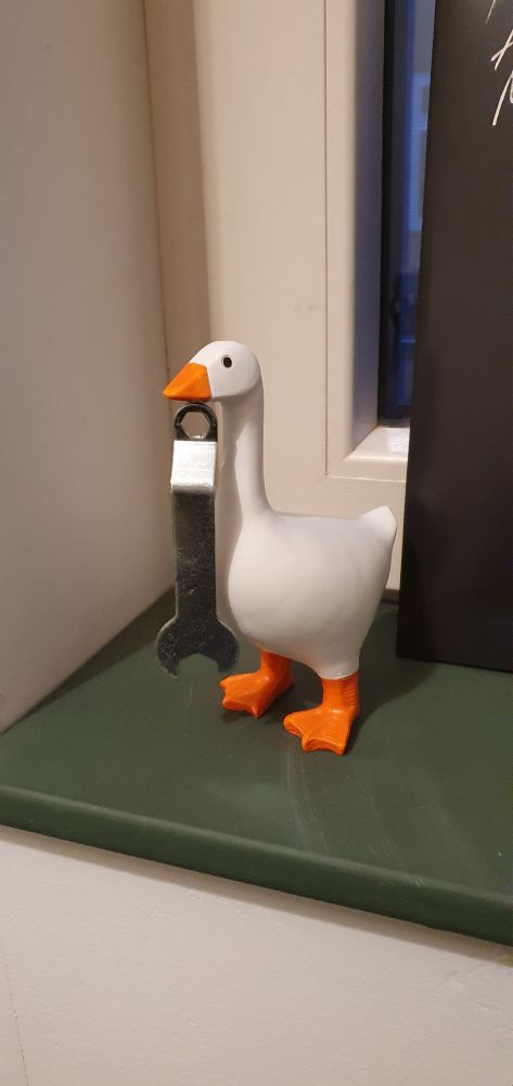 Goose figurine holding a wrench