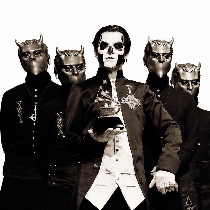 the band ghost, papa is holding a grammy and flanked by the nameless ghouls