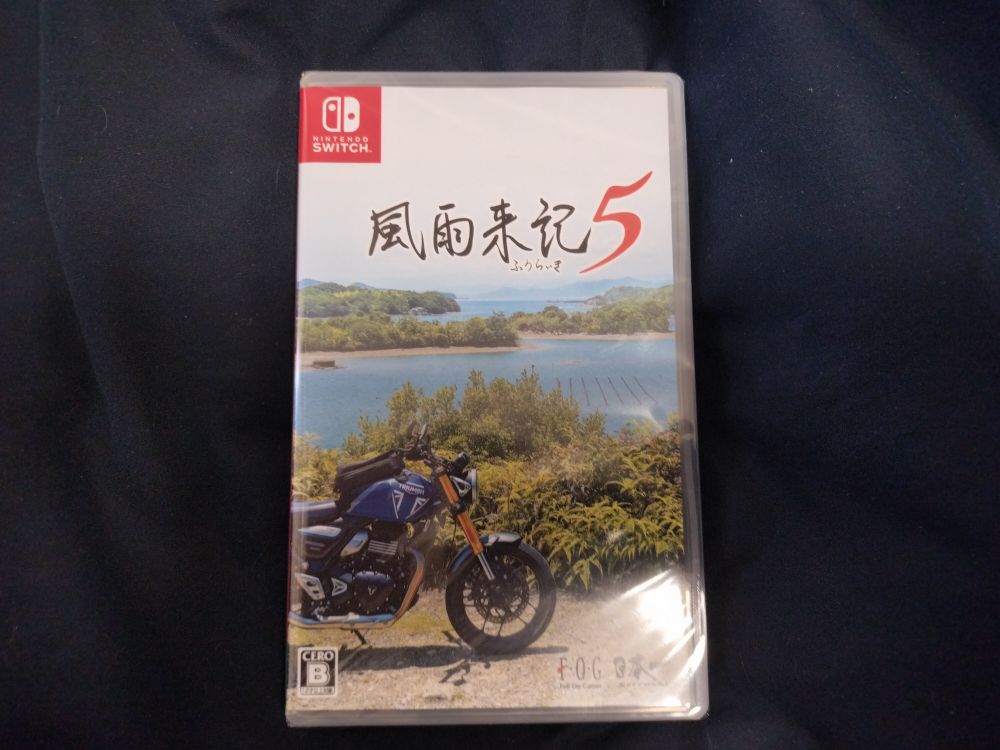 A new boxed copy of Fuuraiki 5 for the Nintendo Switch lying on dark blue cloth
