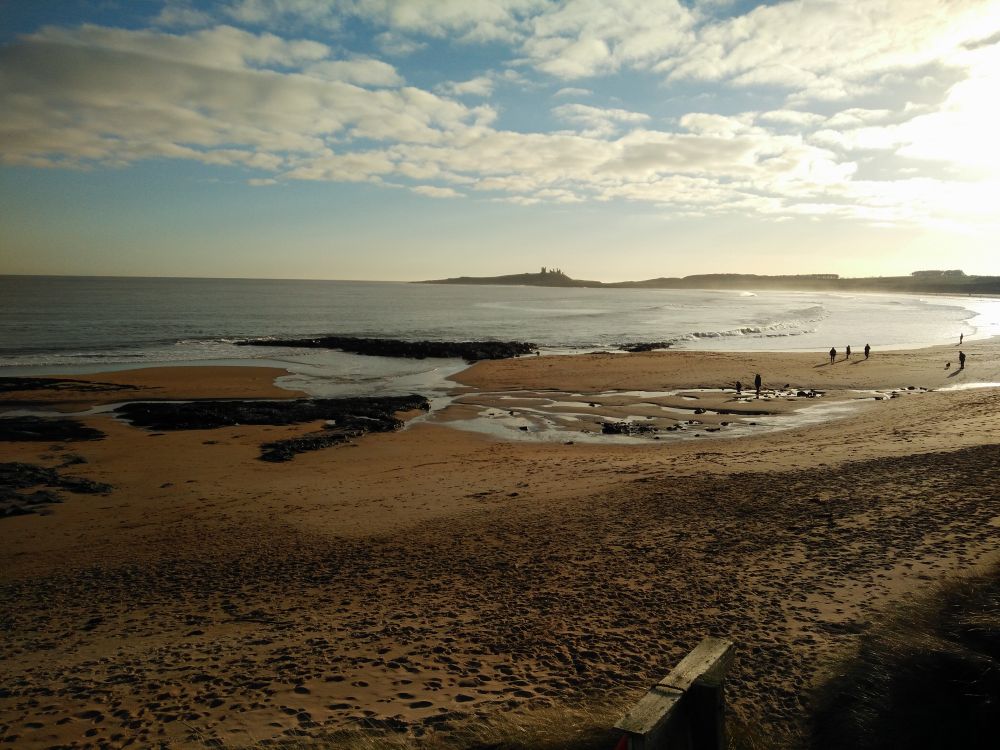 Distant view of Dunstanburgh Castle from Embleton Bay