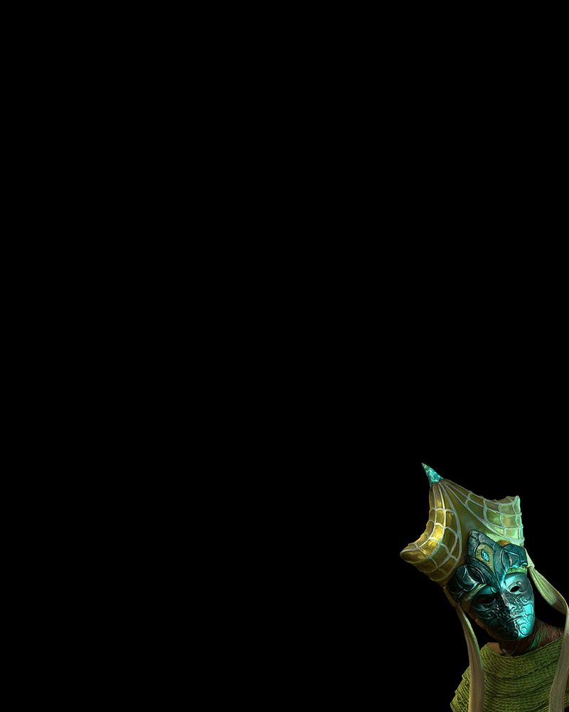 A black image. In the bottom right hand corner, a figure in a mask appears. They are wearing a golden headpiece, which is adorned with a web-like pattern.